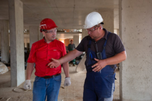 Two men having a conversation at a construction site