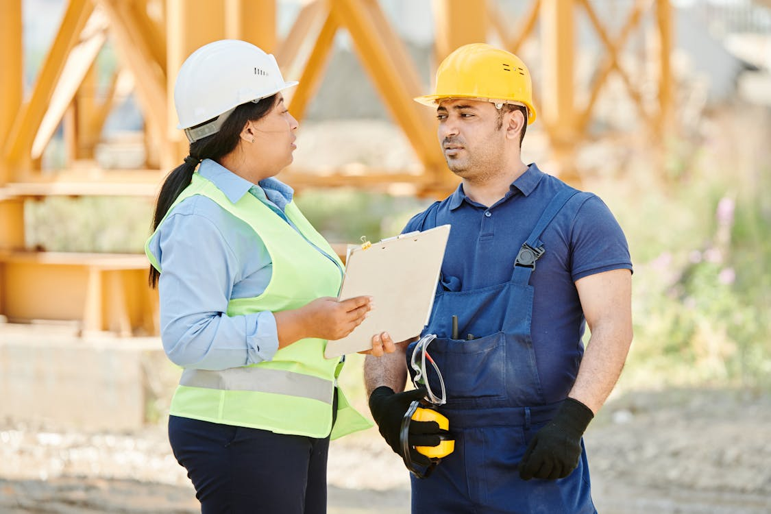A man and woman having a conversation at a construction site