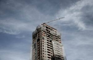 A construction crane atop an under-construction building