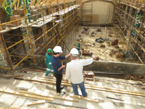 Two men engaged in conversation at a construction site