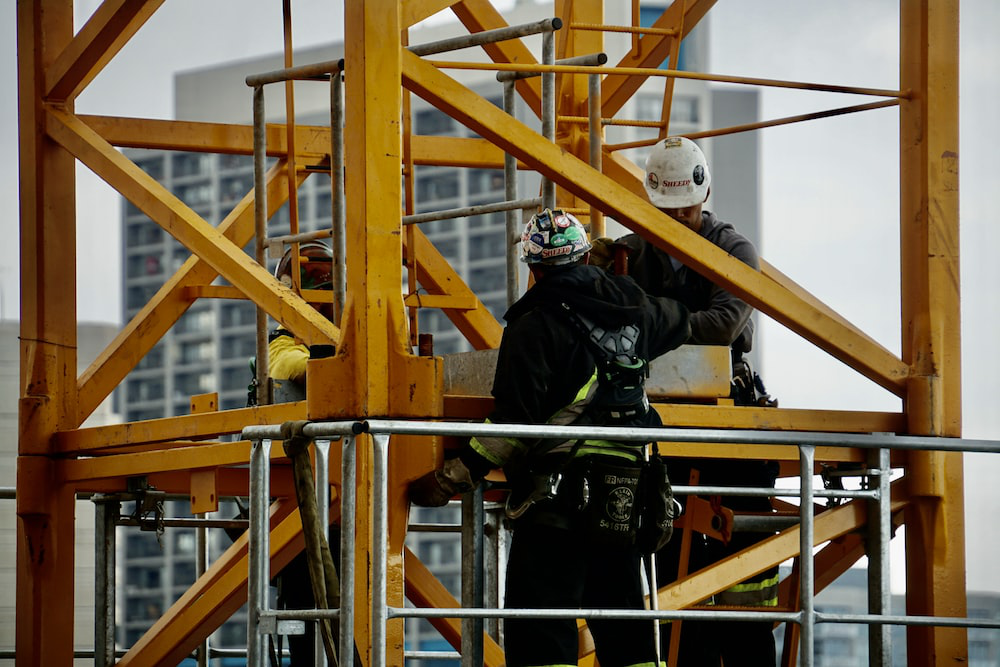 Two men in a lift at a construction site