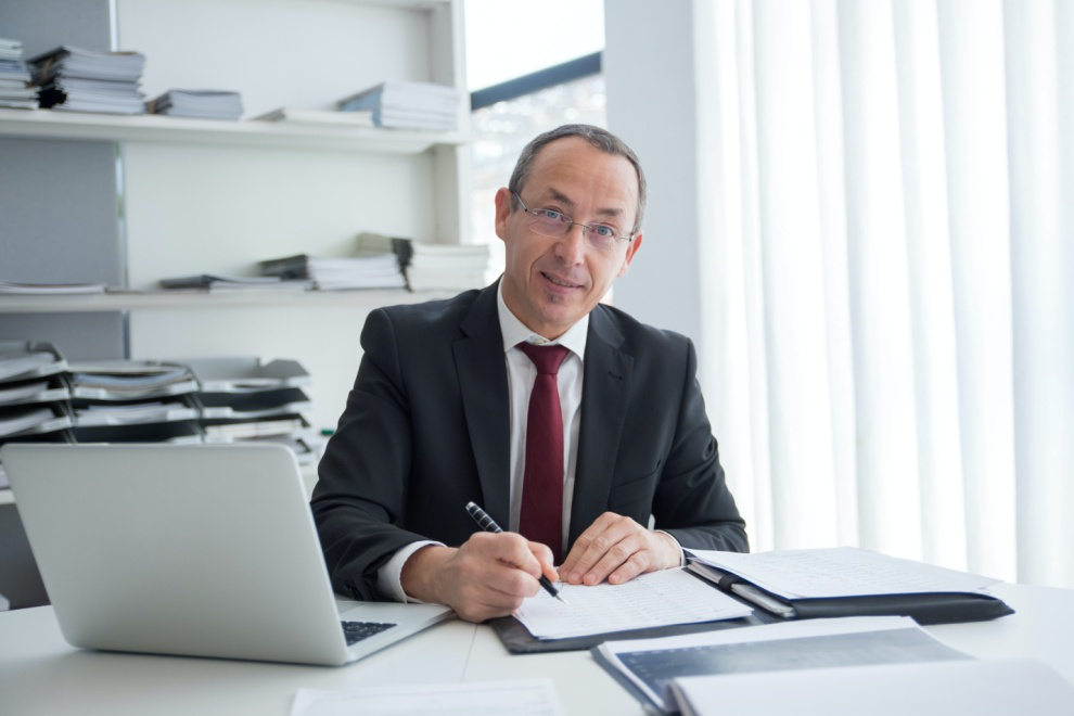 Man in a formal suit working on legal documents