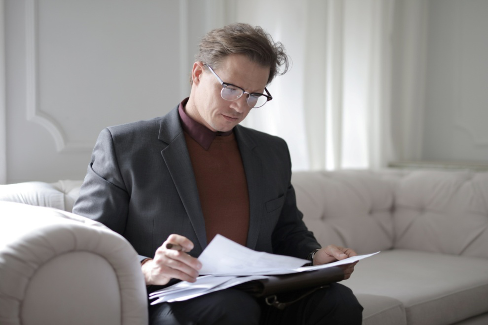 Man in specs reading legal documents