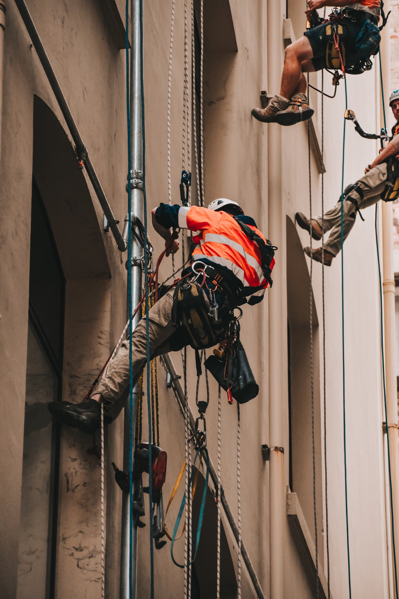 Workers ensuring safe crane operations at a high-rise site