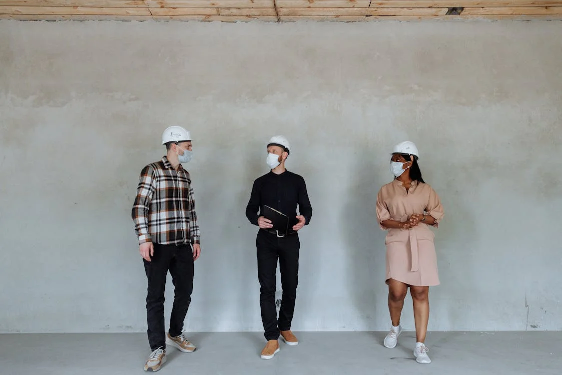  An image of people wearing helmets at a construction site  