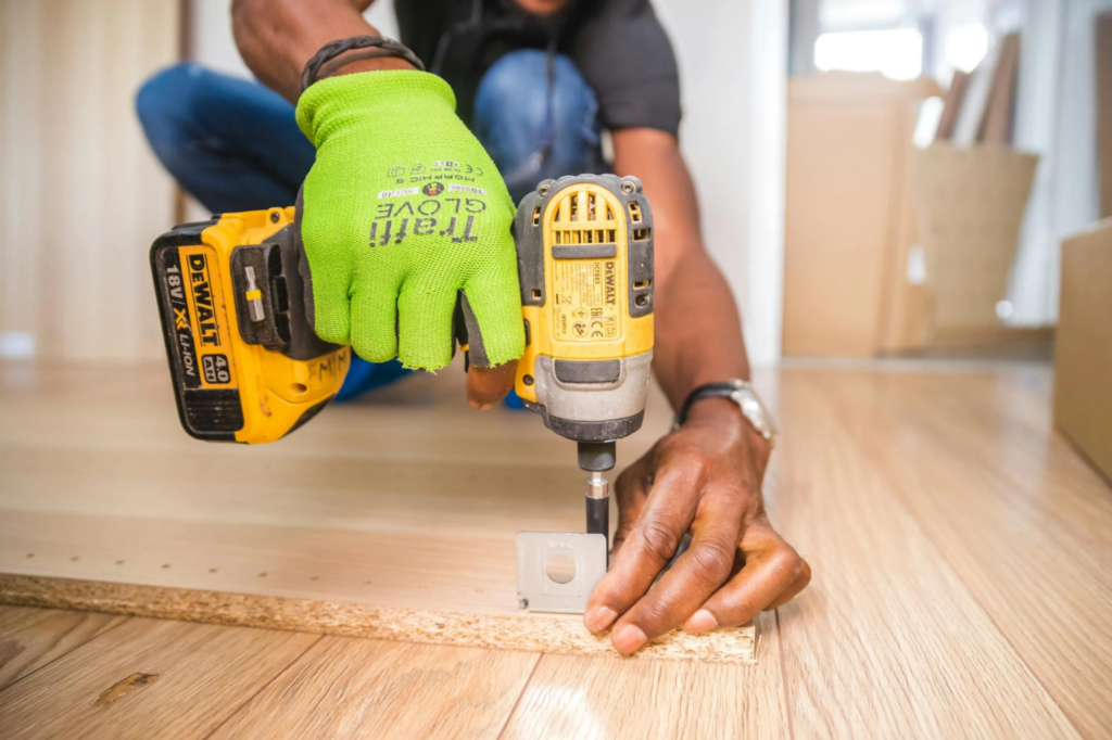 A construction worker uses a drill.