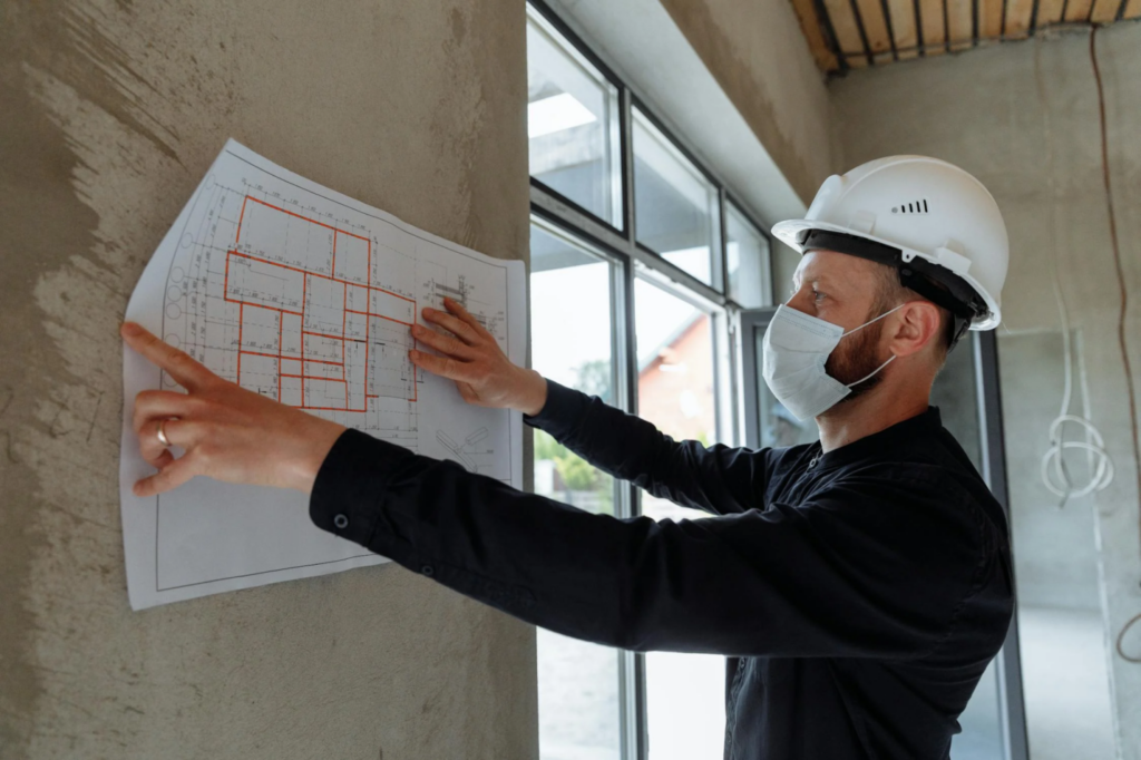 A contractor reviews blueprints