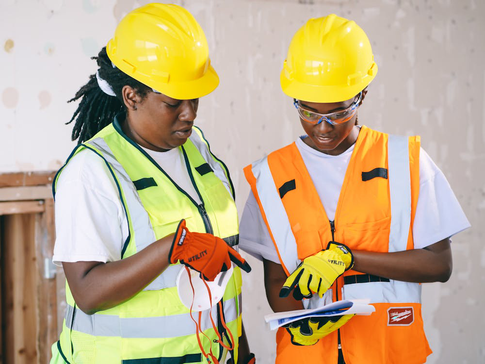Engineers reviewing project schedule documents on a construction site