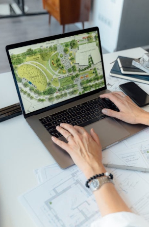 A person typing on a laptop at a desk.