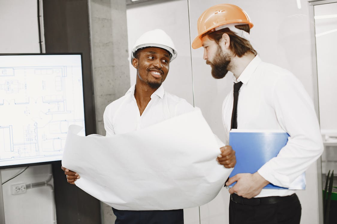An image of construction workers wearing helmets