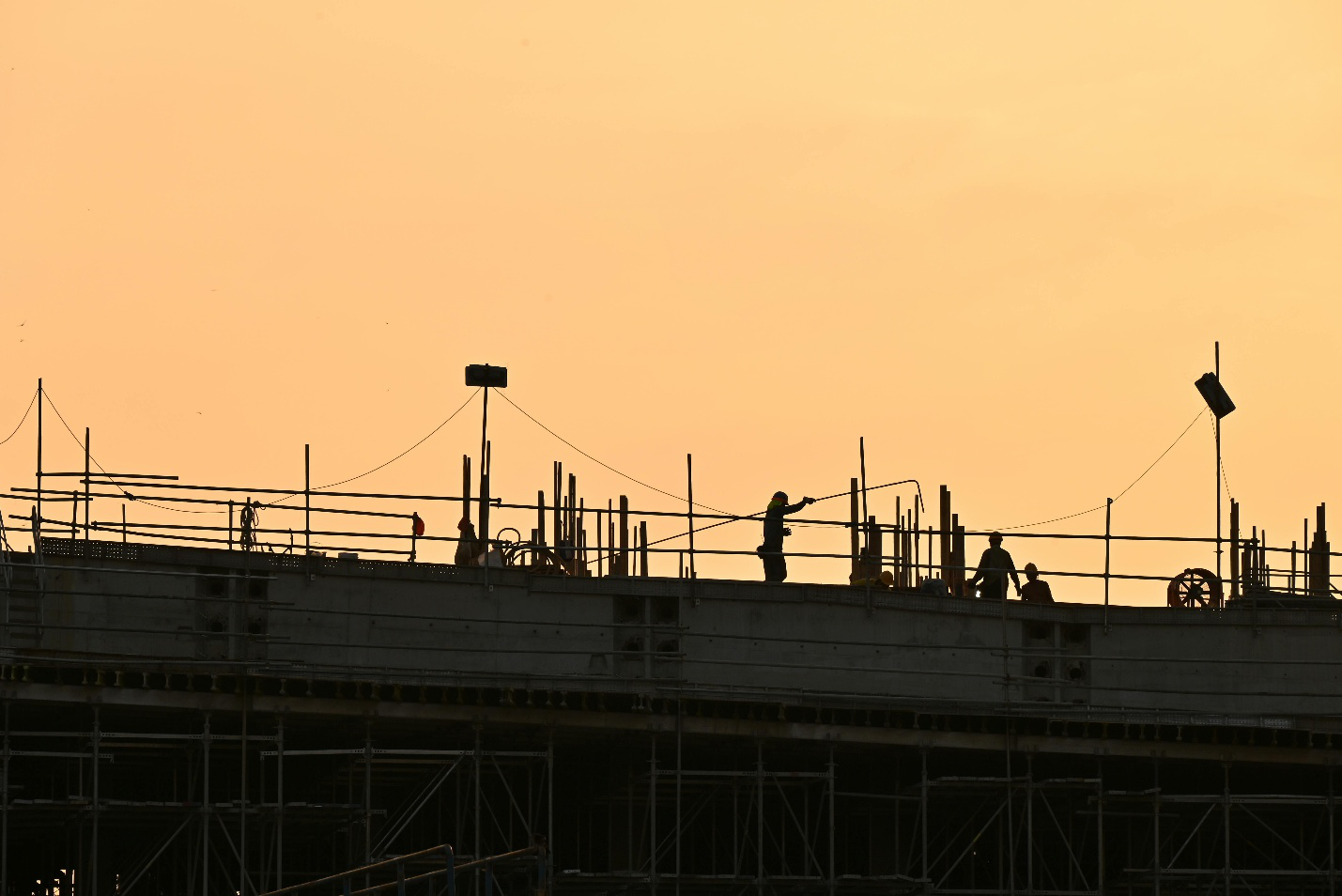 Silhouette of construction workers outside